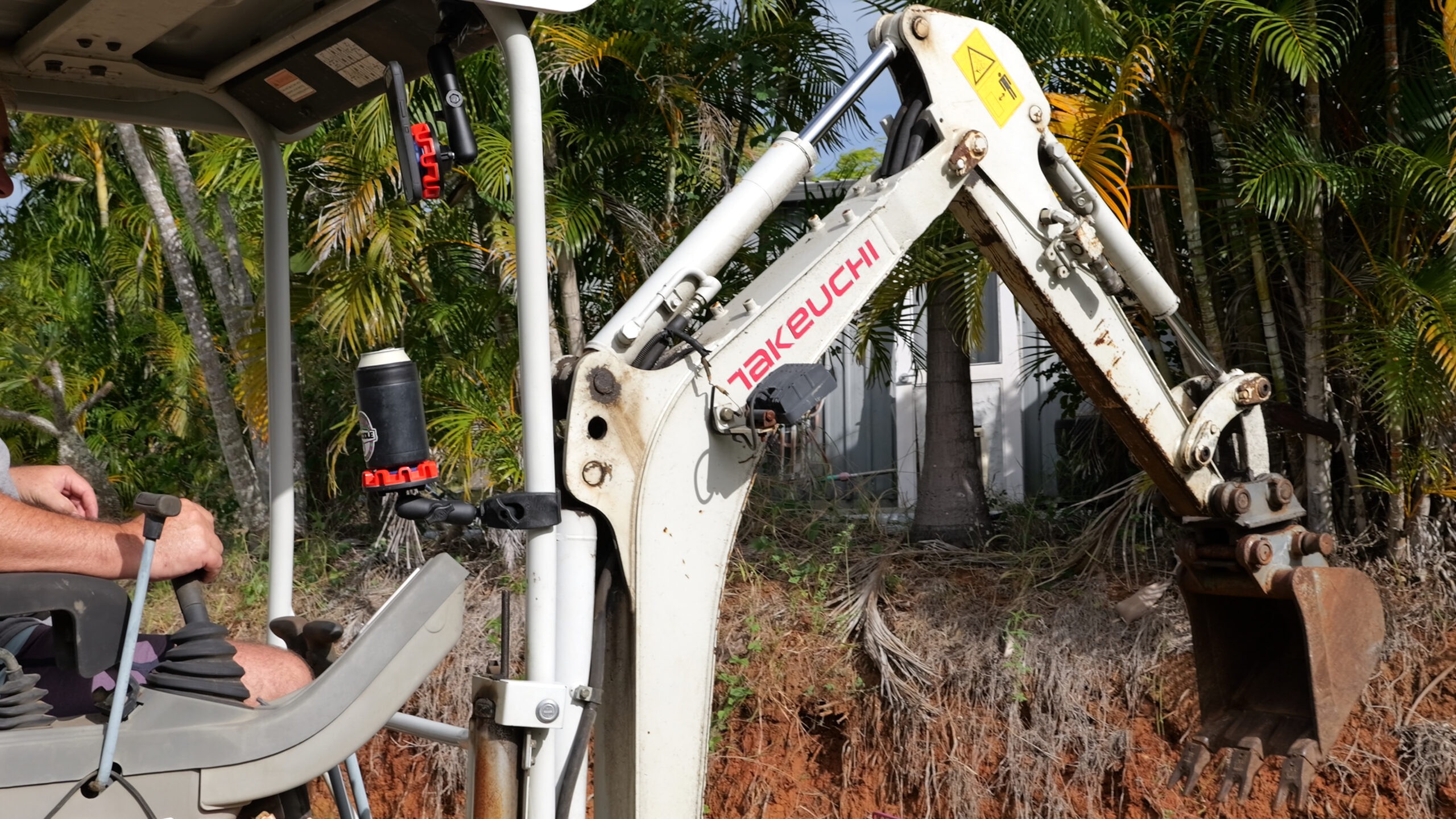 Dnoodle ute phone mount installed in excavator cab holding phone and insulated drink cooler