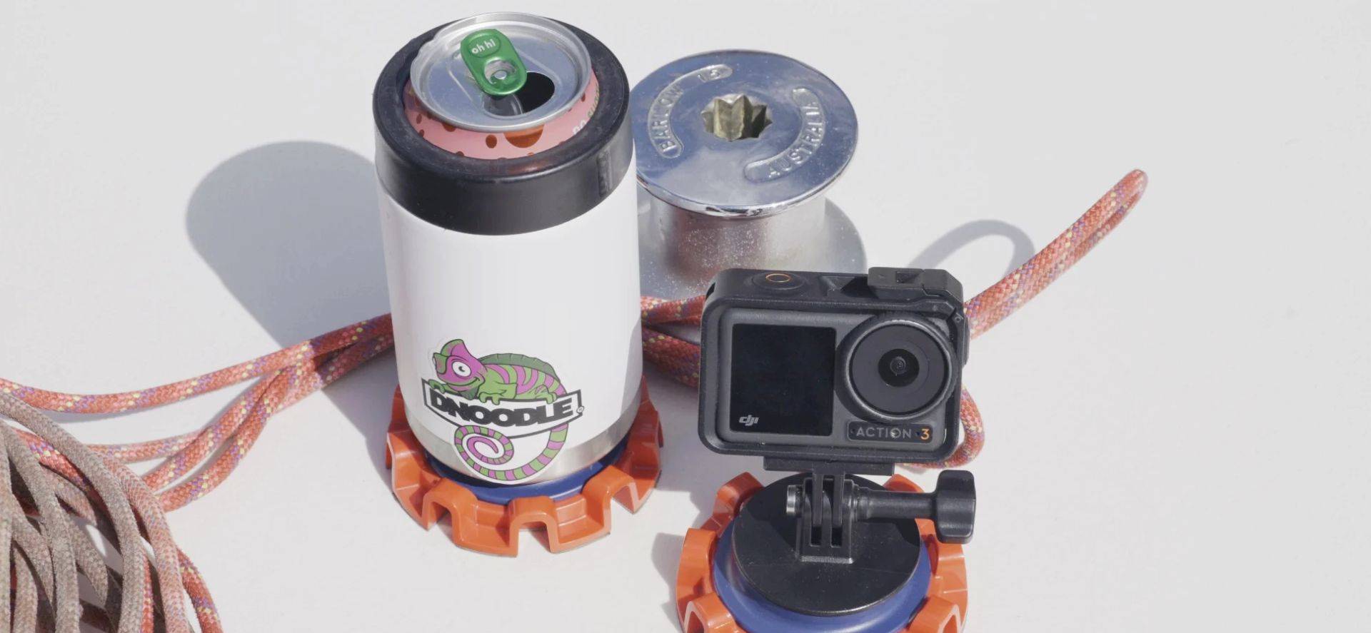 Two Dnoodle setups, one holding an action camera and the other holding an insulated cooler.